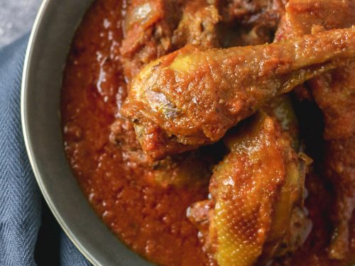 Nigerian chicken stew on a plate, the chicken used is the hard type that is flavourful and fried